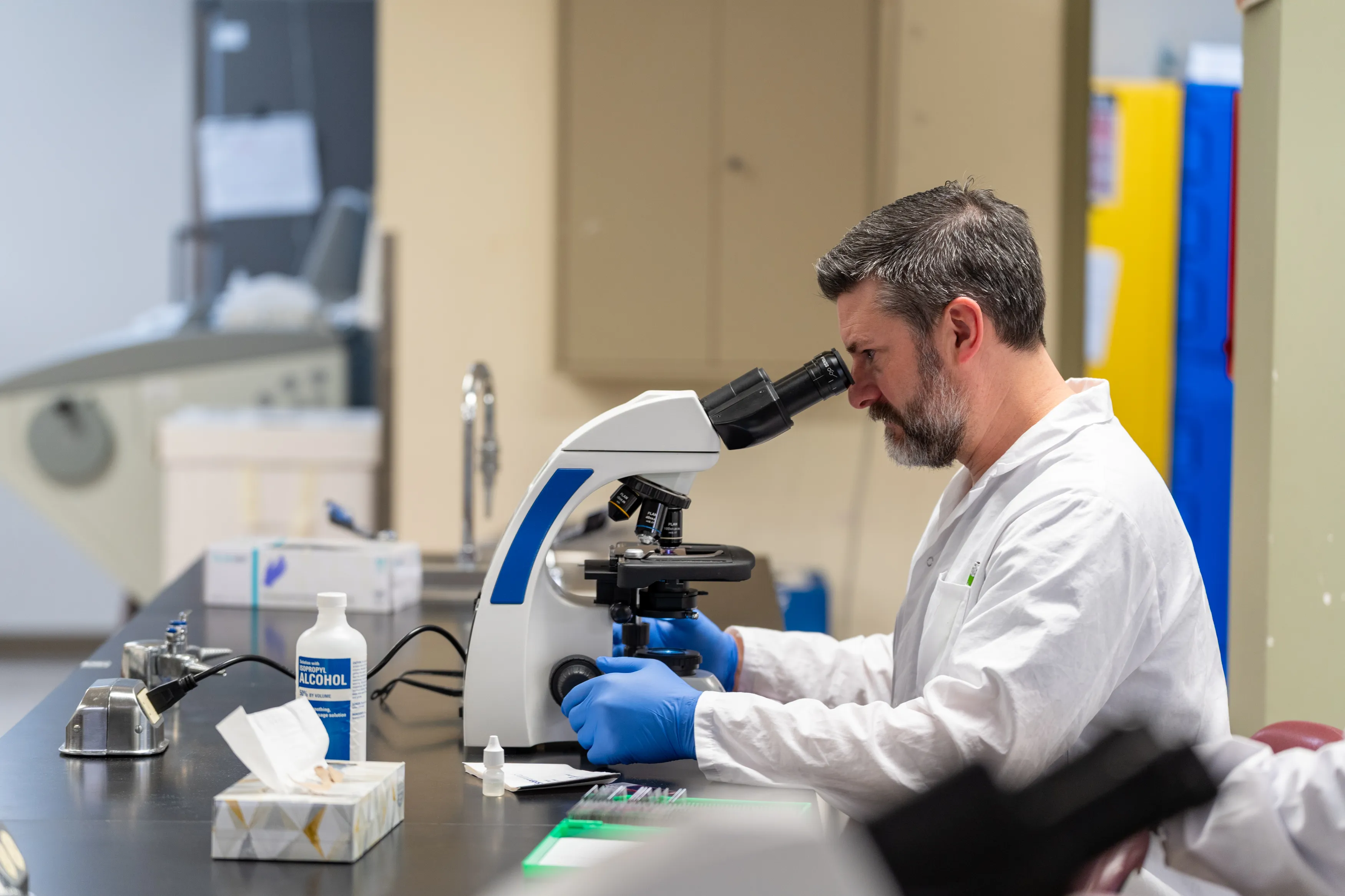 Lab researcher using microscope